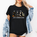 Just A Horror Goose Halloween Spooky Playful Creepy Quirky Festive Nighttime Chills Graphic Tee